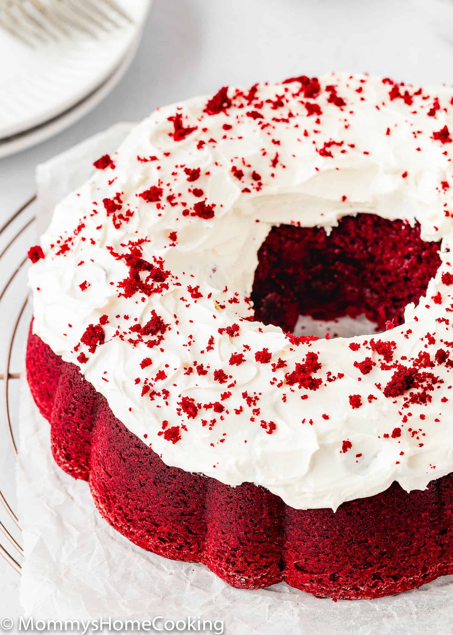Eggless Red Velvet Bundt Cake topped with Cream cheese frosting.