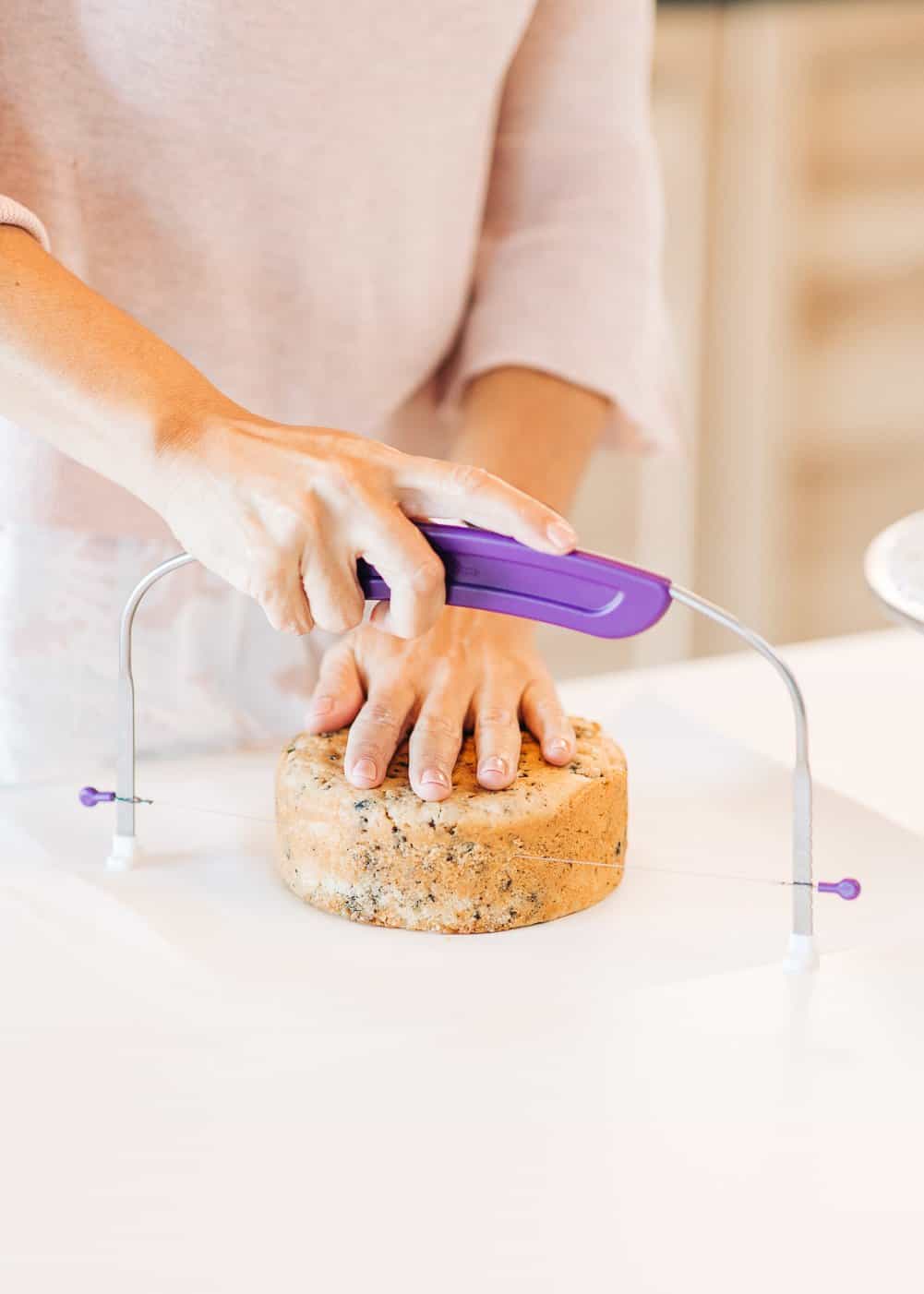 women cutting the tops of a cake