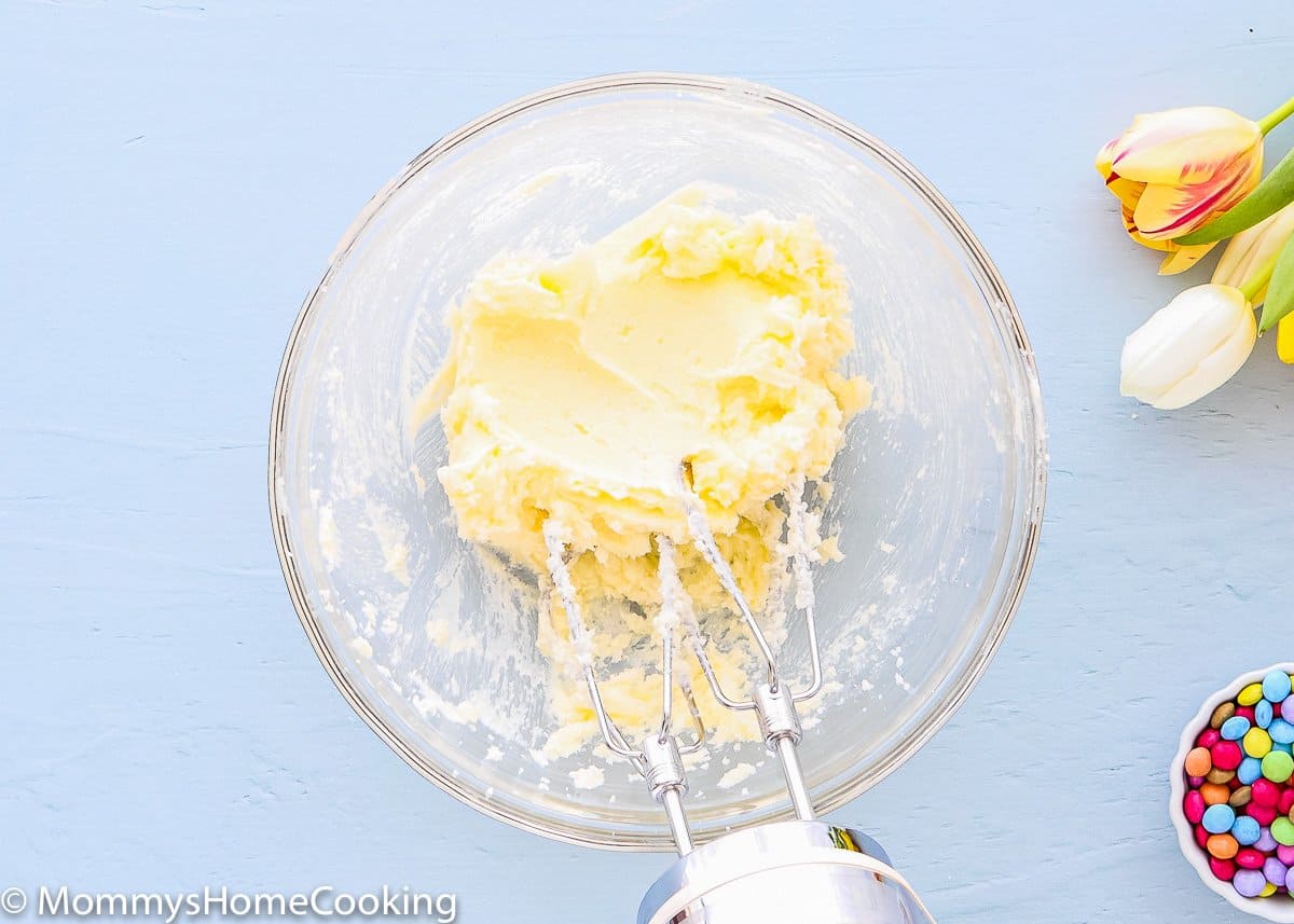butter and sugar creamed together in a bowl with a hand mixer