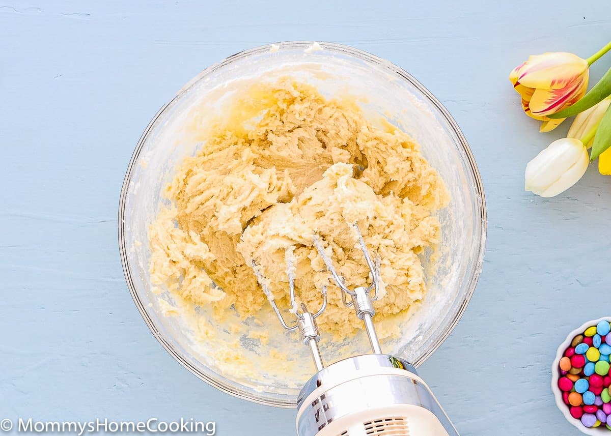 egg free cookie dough in a bowl with a hand mixer