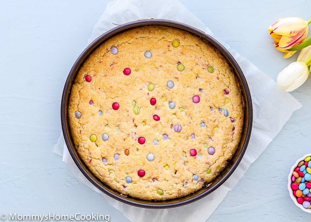 baked egg free cookie cake into a springform pan with chocolates candies in top