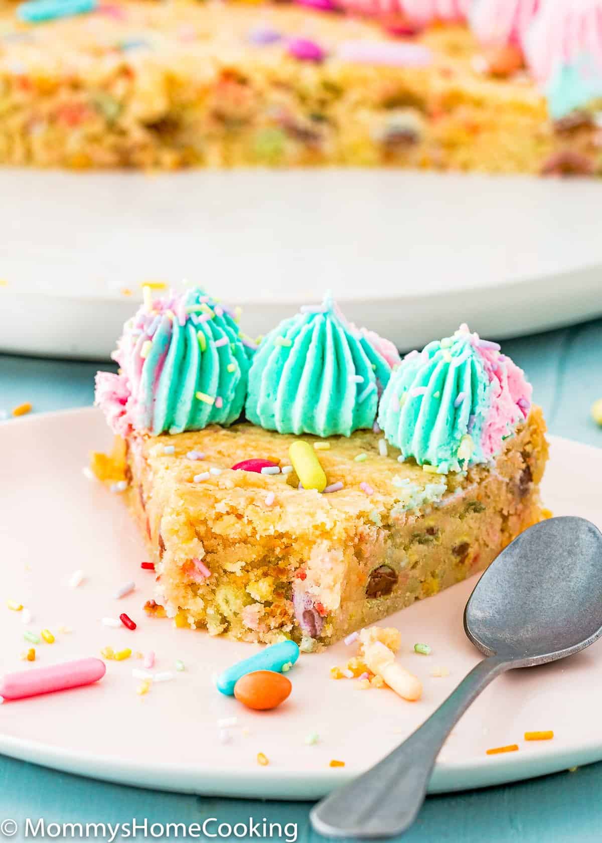 Eggless Cookie Cake slice on a plate with a spoon
