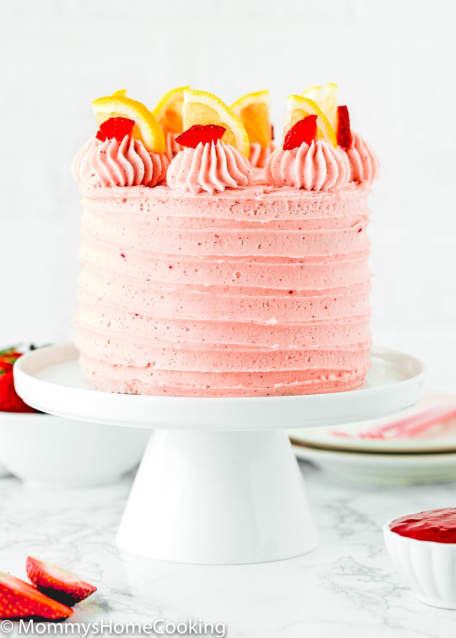 Eggless Strawberry Lemonade Cake on a white cake stand 
