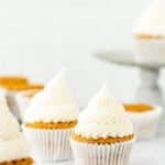 eggless carrots cupcakes frosted with cream cheese frosting that isn't runny