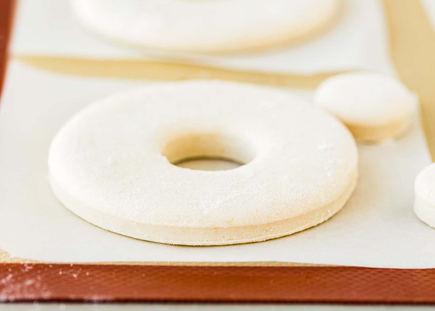 unfried egg-free donuts  over a silicone mat. 