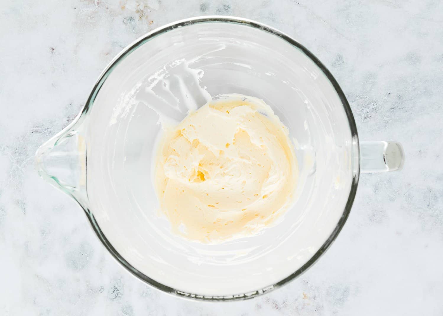 Whipped butter in a stand mixer bowl. 
