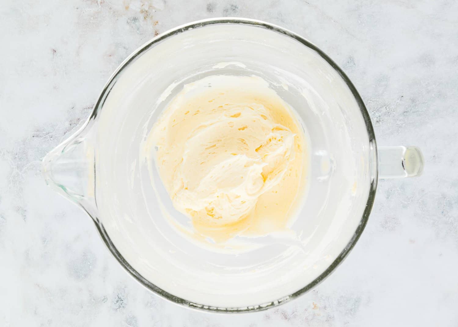 Whipped butter with sugar, vanilla, and salt in a stand mixer bowl. 