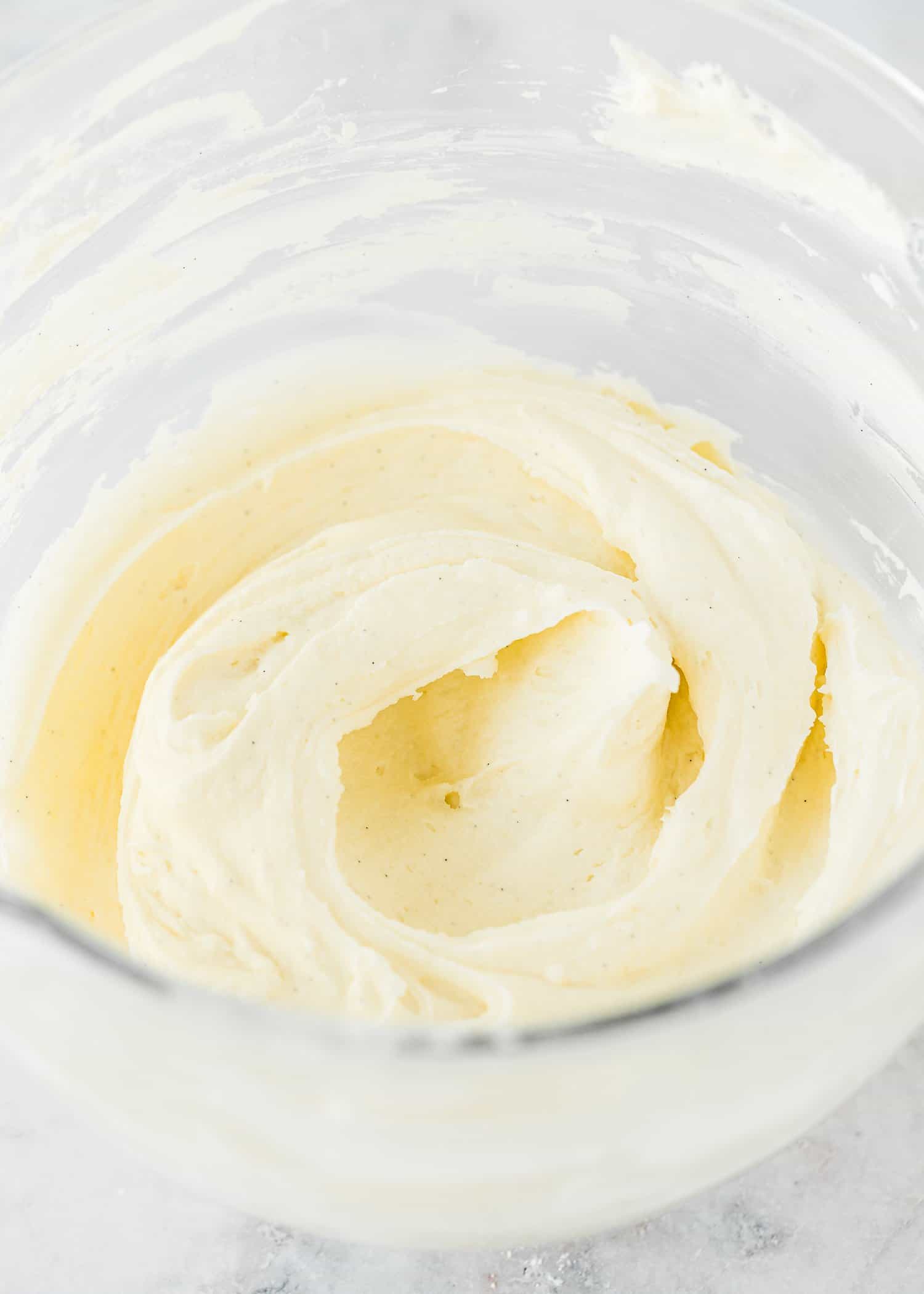 Smooth cream Cheese Frosting in a bowl of a stand mixer. 