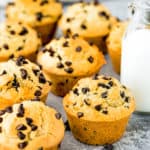 Eggless Bakery-Style Chocolate Chip Muffins over a gray surface