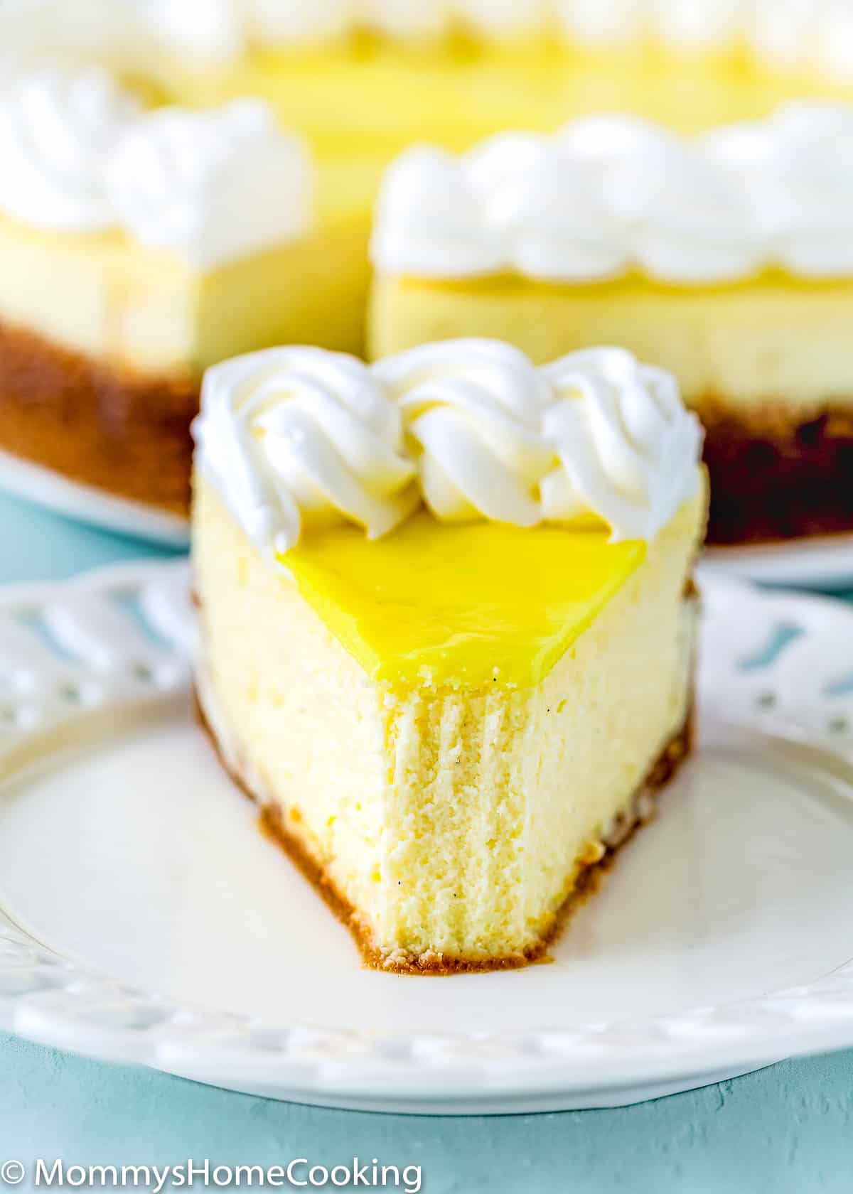 close up of a slice of a eggless lemon cheesecake slice showing its perfect texture.