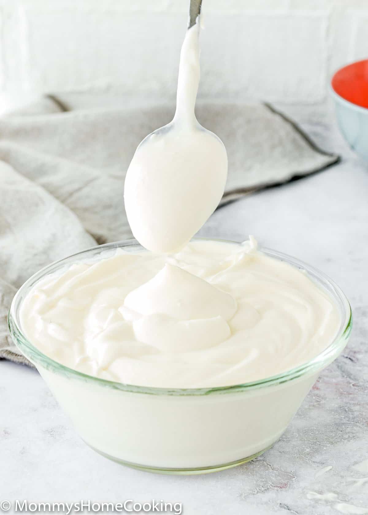 homemade sour cream in a bowl with a spoon