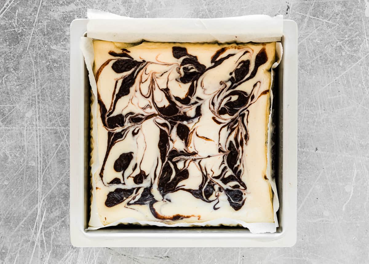 baked eggless cheesecake brownies in a square baking pan. 