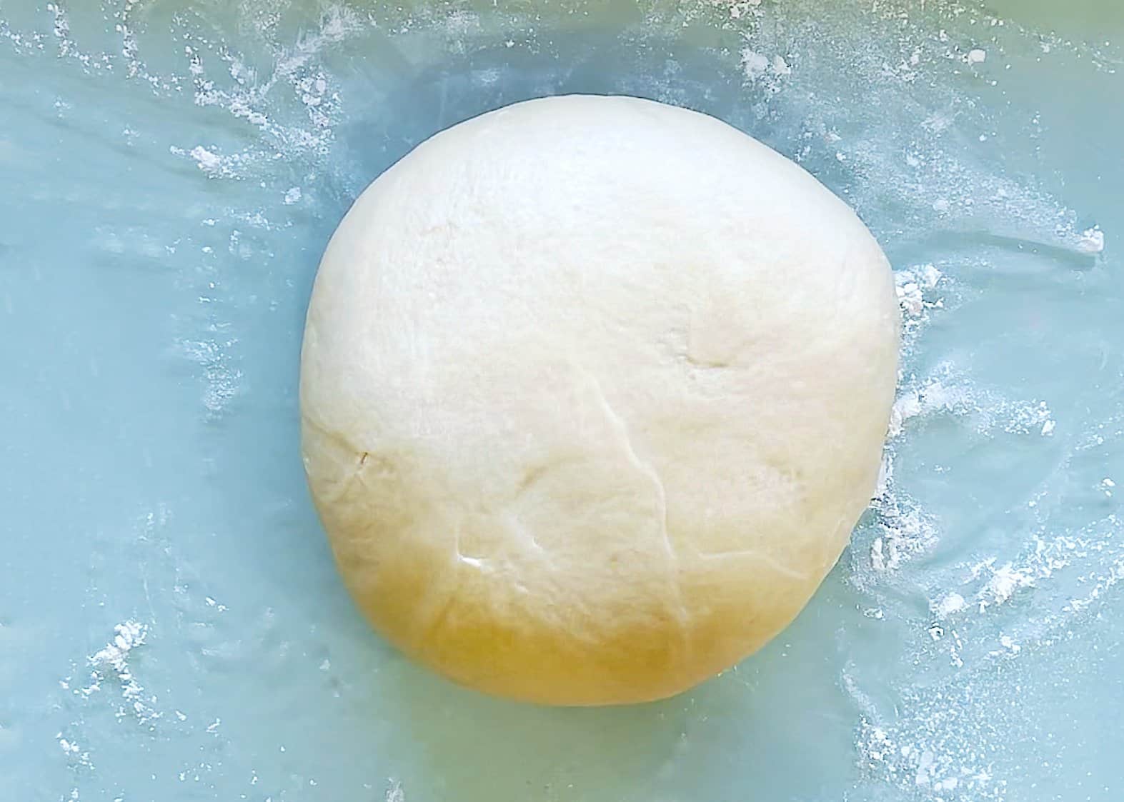 venezuelan tequeños dough over a blue surface. 
