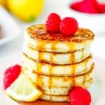 maple syrup poured over a stack of eggless lemon Ricotta pancakes