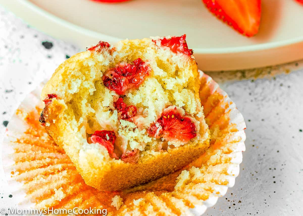 cut open egg-free strawberry muffins showing its fluffy inside texture. 