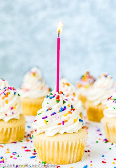 egg free vanilla cupcake with frosting, sprinkles and a candle