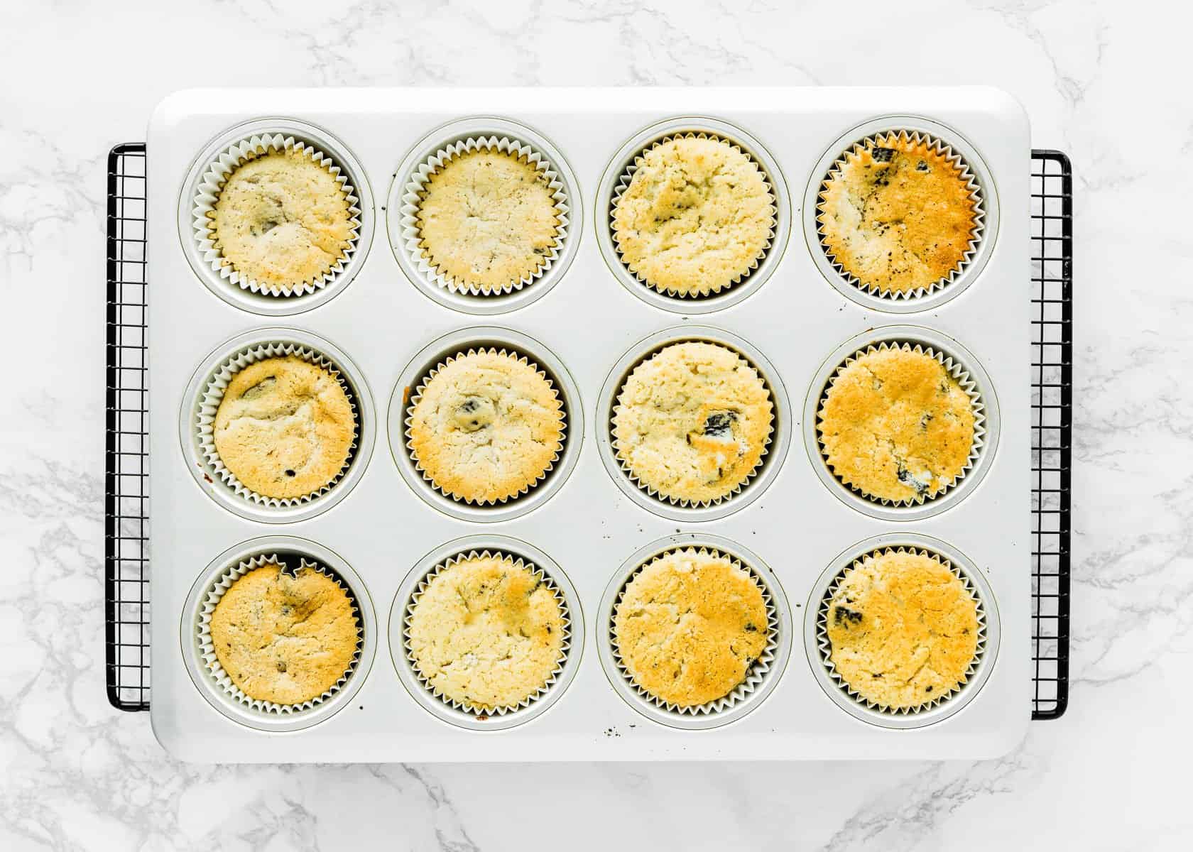 egg-free oreo cupcakes in a cupcake tin over a cooling rack. 