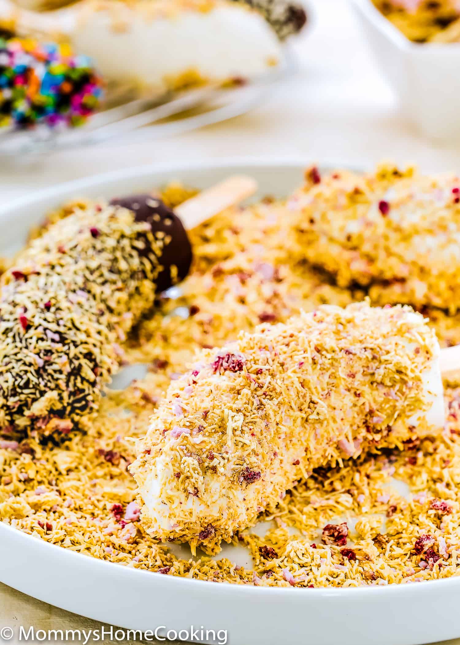 Frozen Banana Pops over a plate.