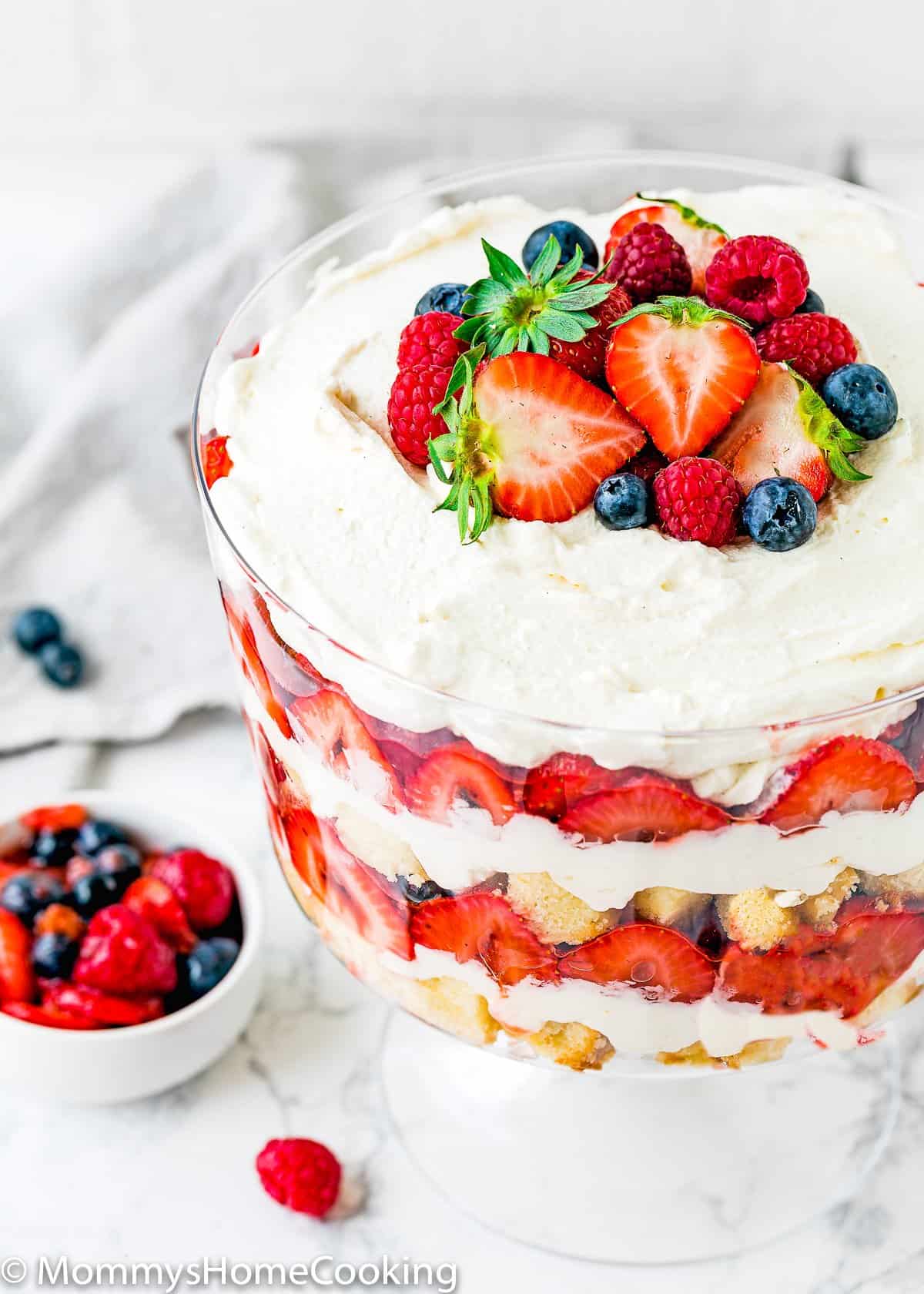 Eggless Berry Trifle Cake with fresh berries on top.