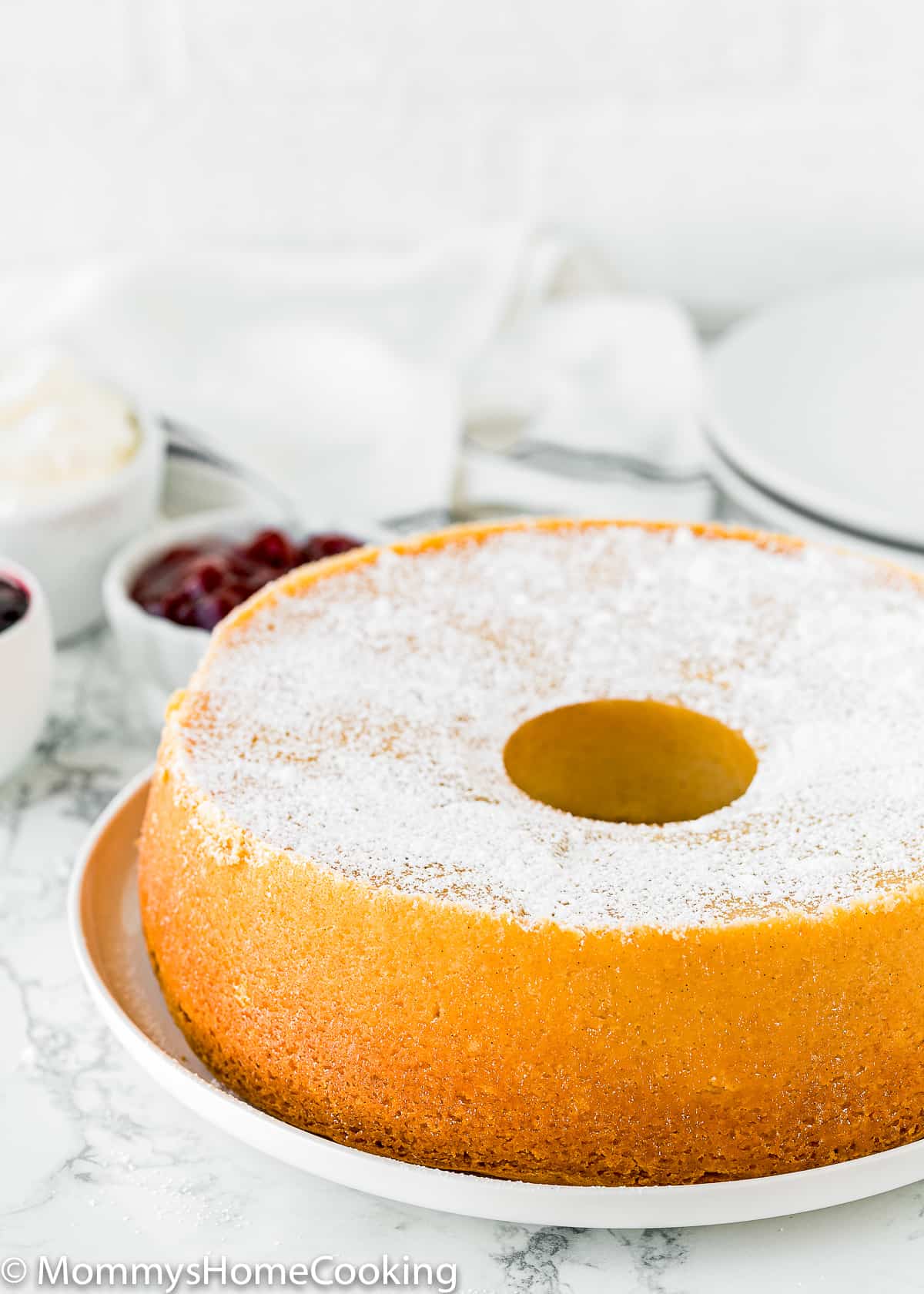 whole Eggless Cream Cheese Pound Cake dusted with confectioners' sugar. 