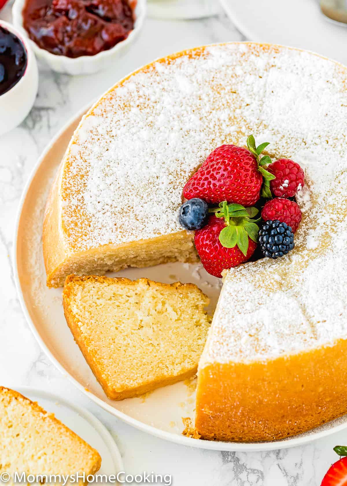 sliced Eggless Cream Cheese Pound Cake on a white serving plate.
