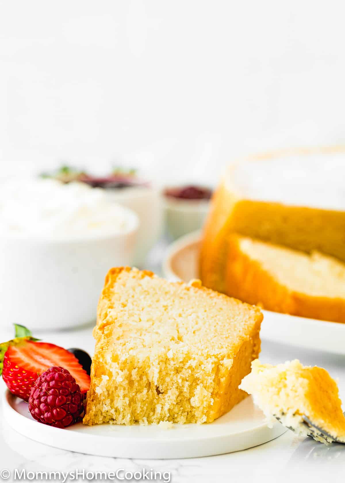 Eggless Cream Cheese Pound Cake slice on a plate with berries.