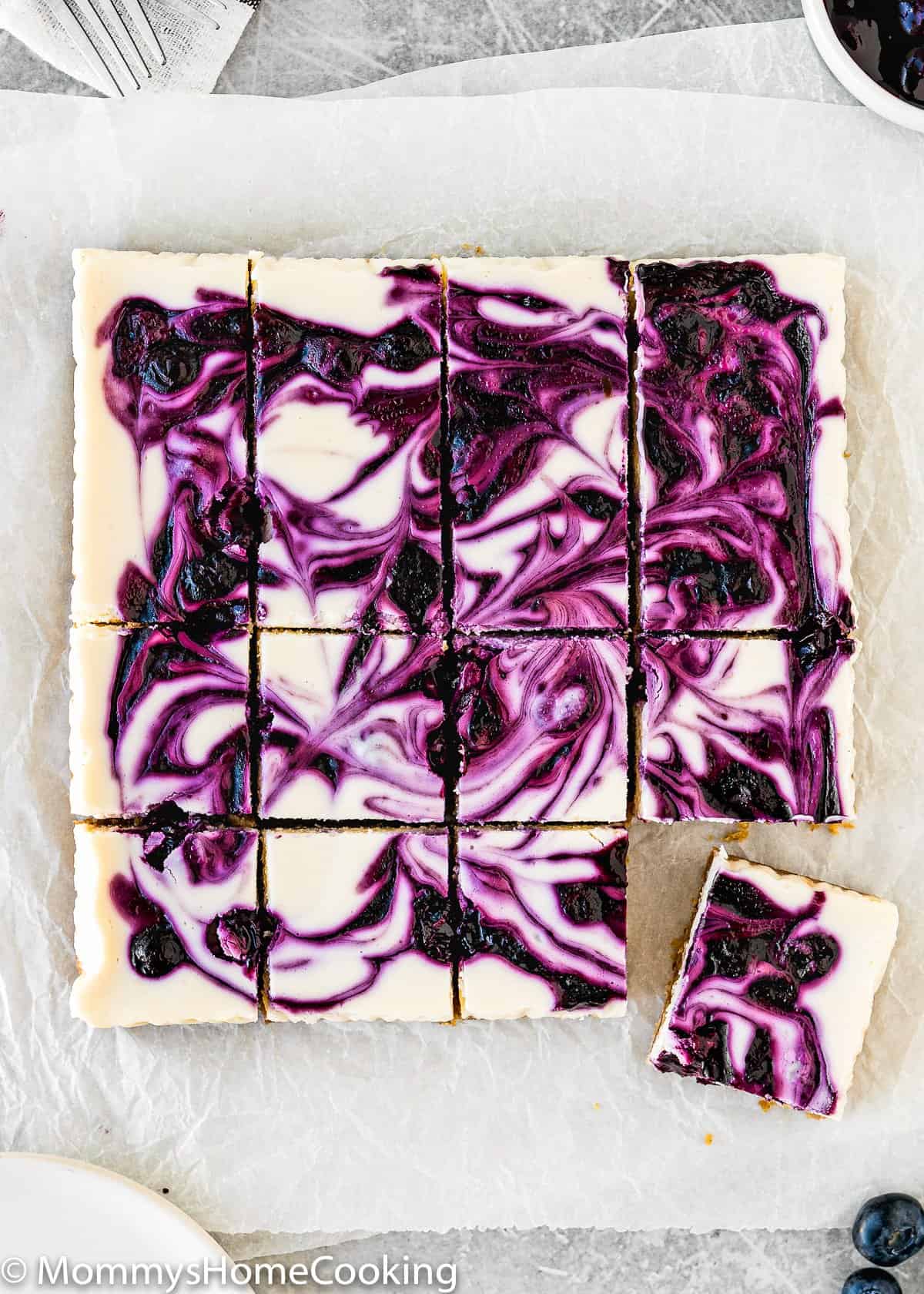 Eggless Lemon Blueberry Cheesecake Bars cut into squares