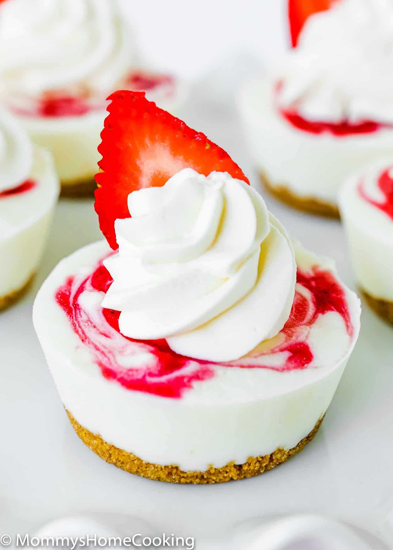 Mini Greek Yogurt Strawberry Cheesecake with whipped cream on top. 