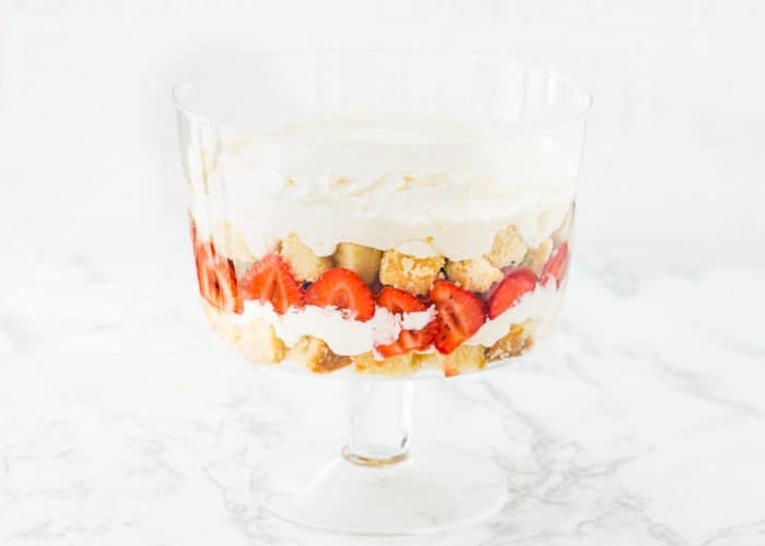 four layers of egg-free trifle in a trifle dish. 