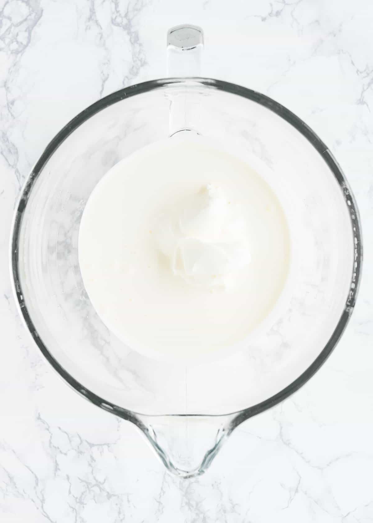 cream cheese and whipped cream in a glass bowl.