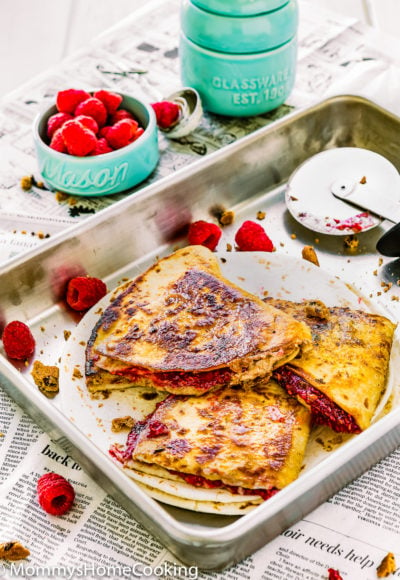 sweet quesadillas in a baking pan with fresh raspberries