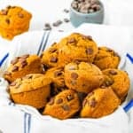 Eggless Chocolate Chip Pumpkin Muffins on a plate with a kitchen napkin