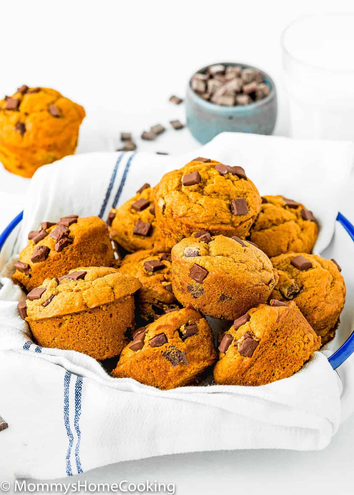 Eggless Chocolate Chip Pumpkin Muffins on a plate with a kitchen napkin.