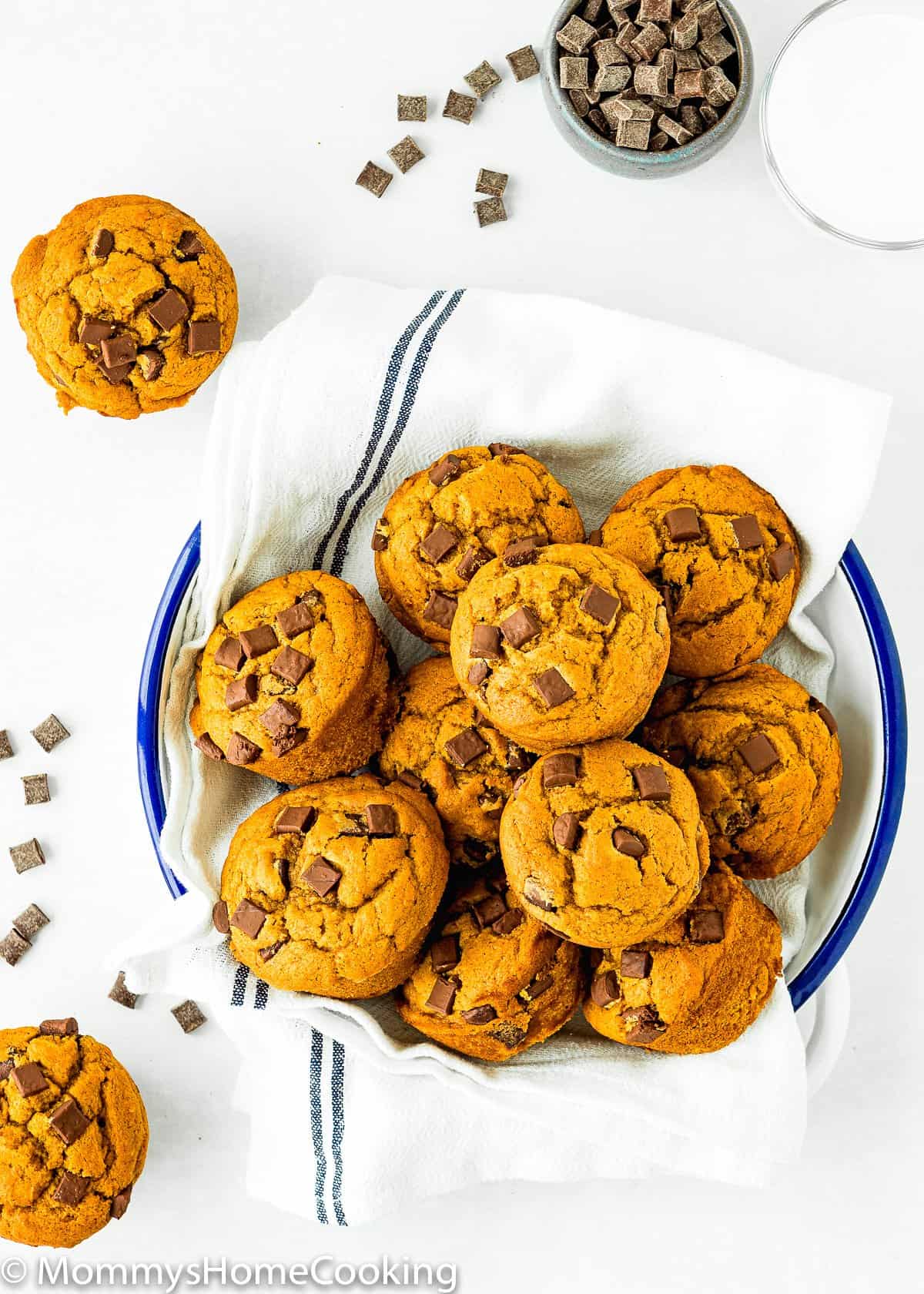 overhead view of Eggless Chocolate Chip Pumpkin Muffins on a plate with a kitchen napkin