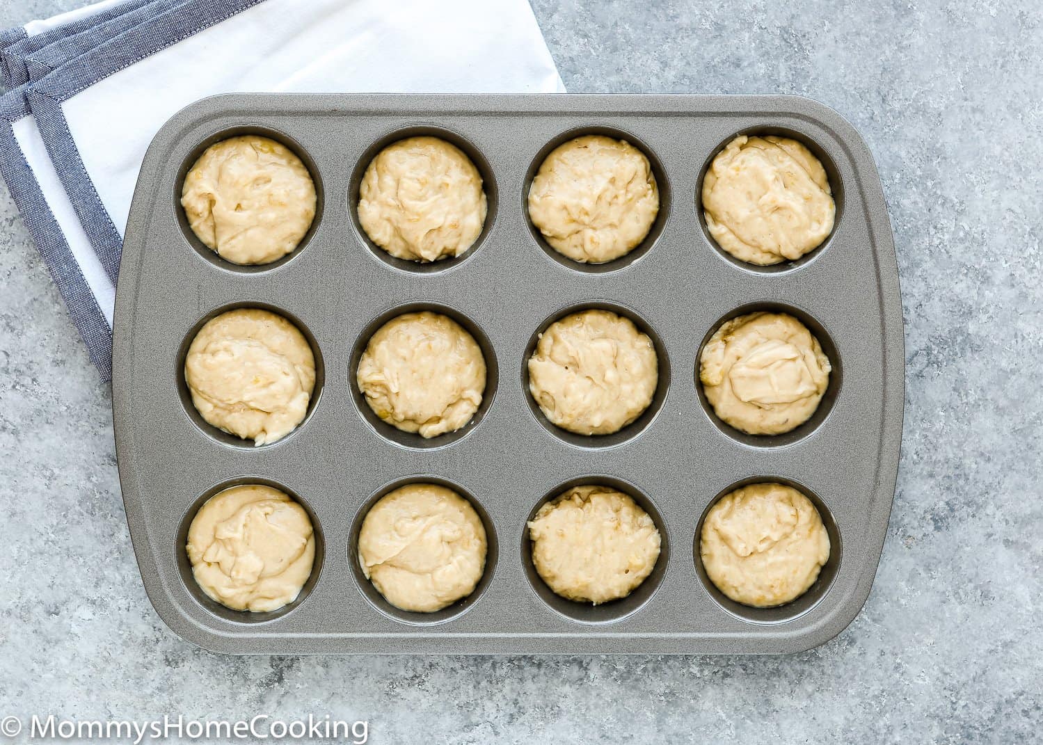 muffin pan filled with egg-free banana muffin batter. 