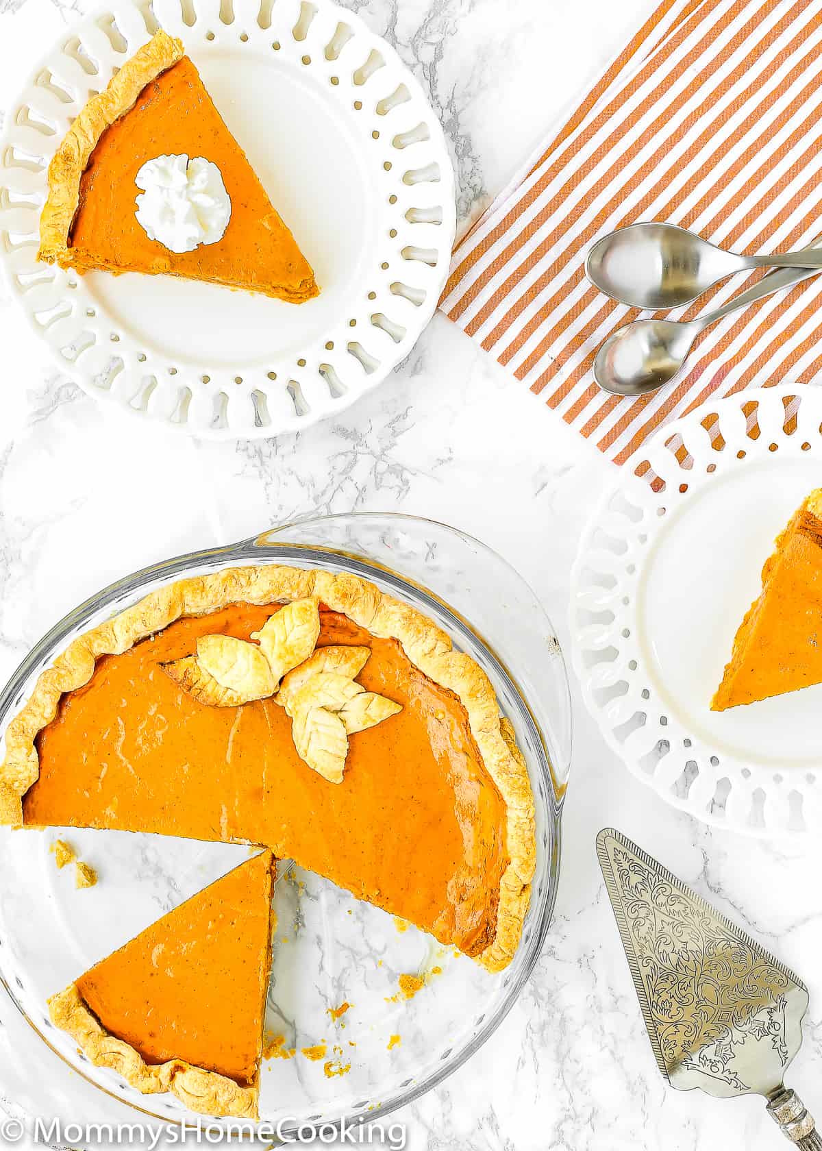 slices Eggless Pumpkin Pie with two white plates and two spoons over a marble surface