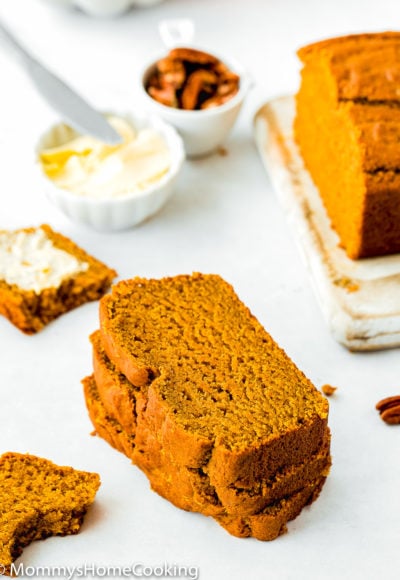 slices of Eggless Pumpkin Bread with butter in the background
