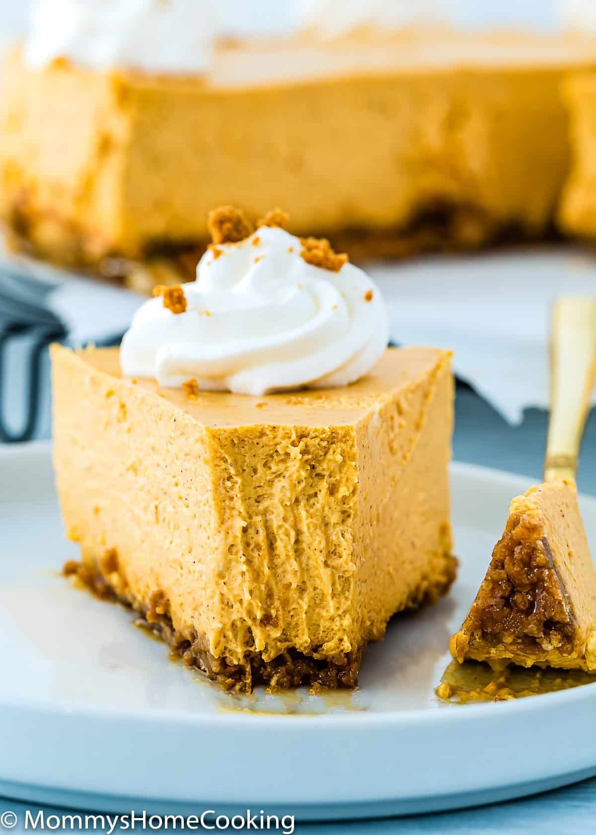 slide of eggless pumpkin cheesecake  on a plate with a fork.