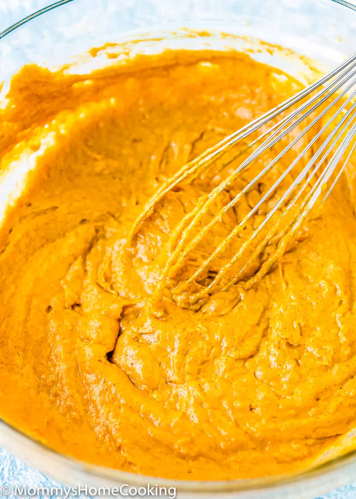Eggless Pumpkin Muffins batter in a bowl with a whisk