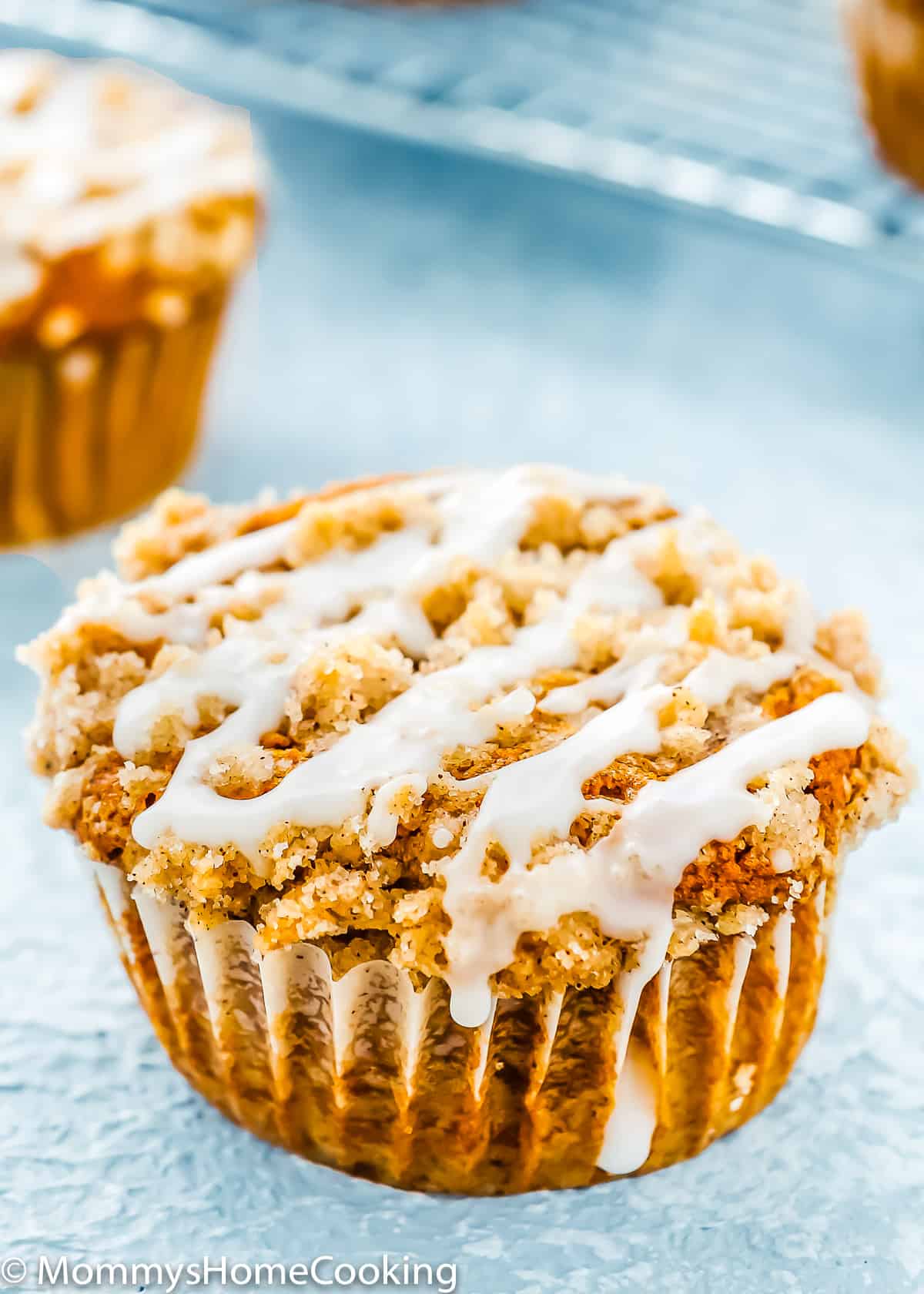 closeup of an Eggless Pumpkin Crumb Muffin with glaze