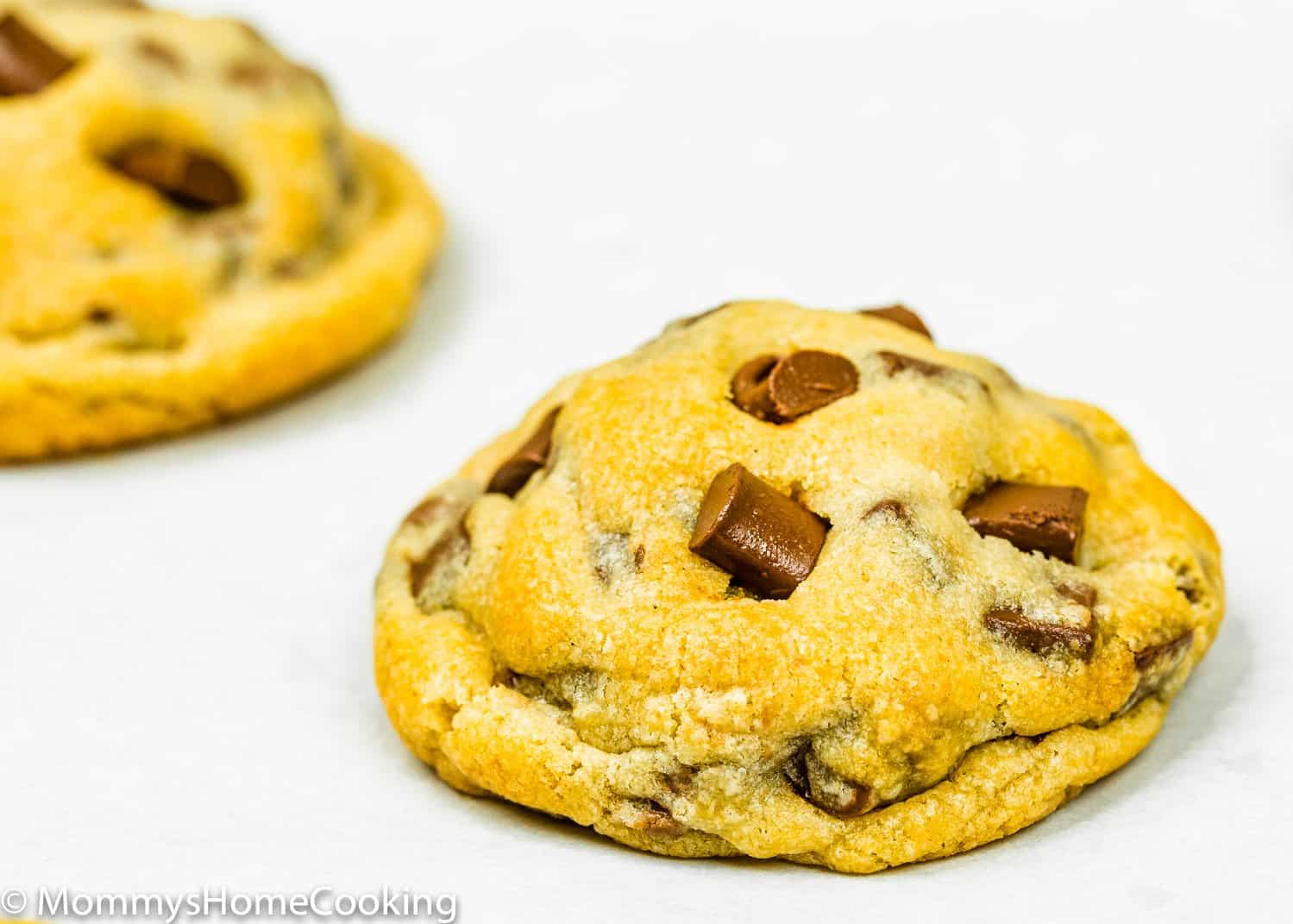 baked eggless chocolate chip cookies over a white surface. 