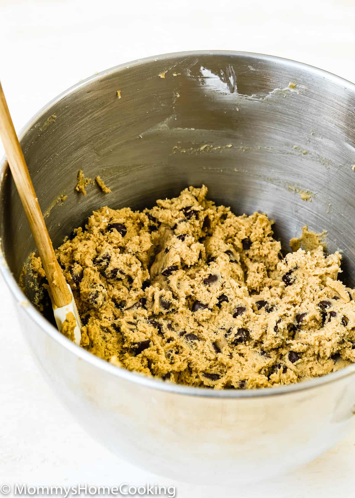 Eggless chocolate chip cookie batter in a mixing bowl.