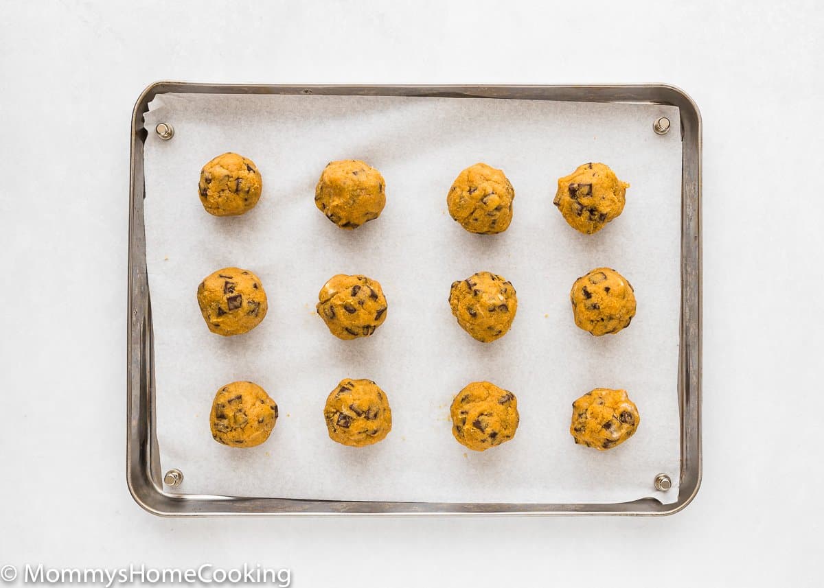Eggless Pumpkin Chocolate Chip Cookies dough balls in a cookie sheet.