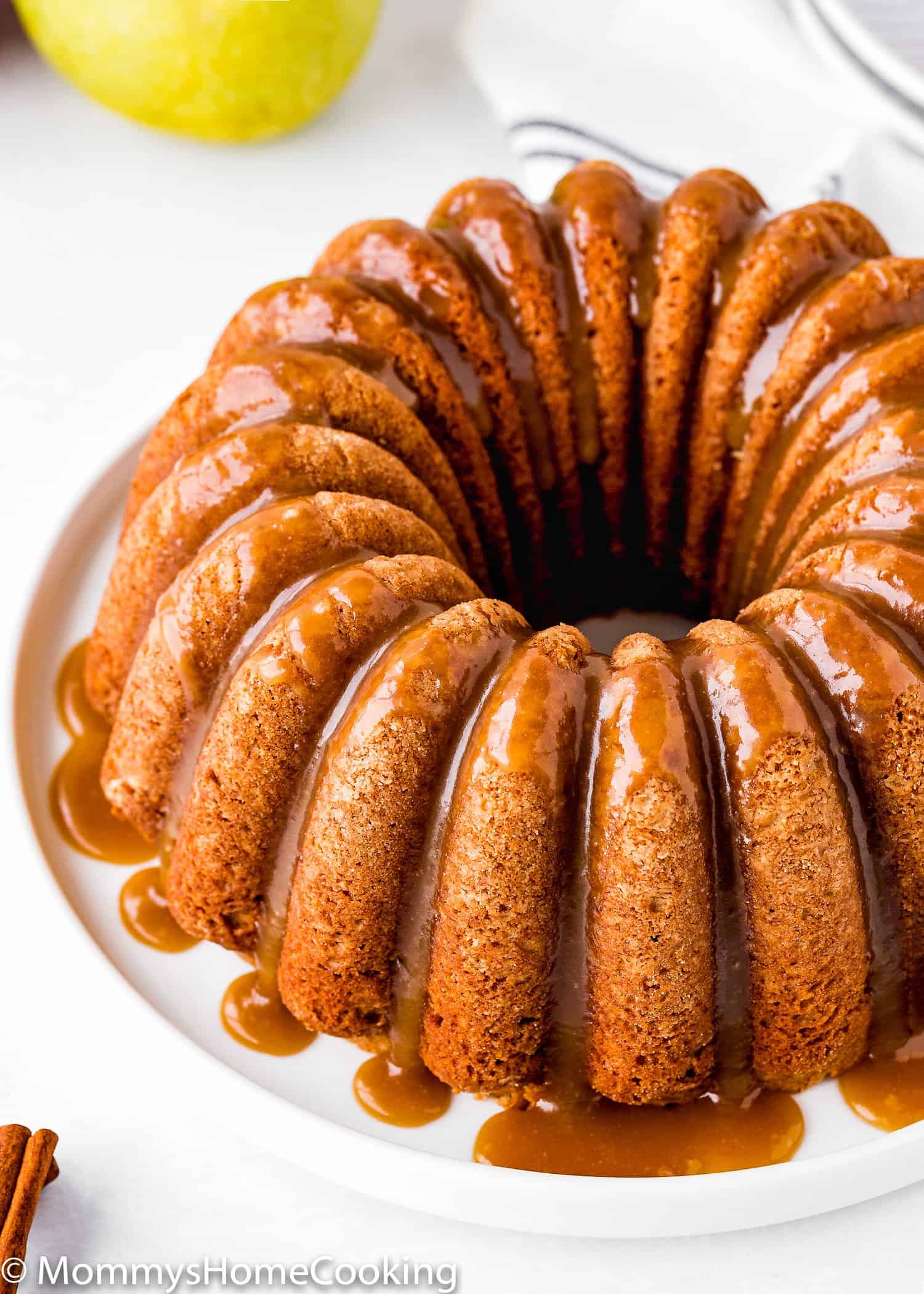 Eggless Apple Cider Donut Cake with brown sugar glaze over a white plate