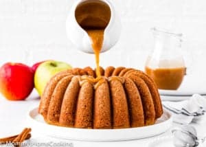 Eggless Apple Cider Donut Cake being drizzled with brown sugar glaze