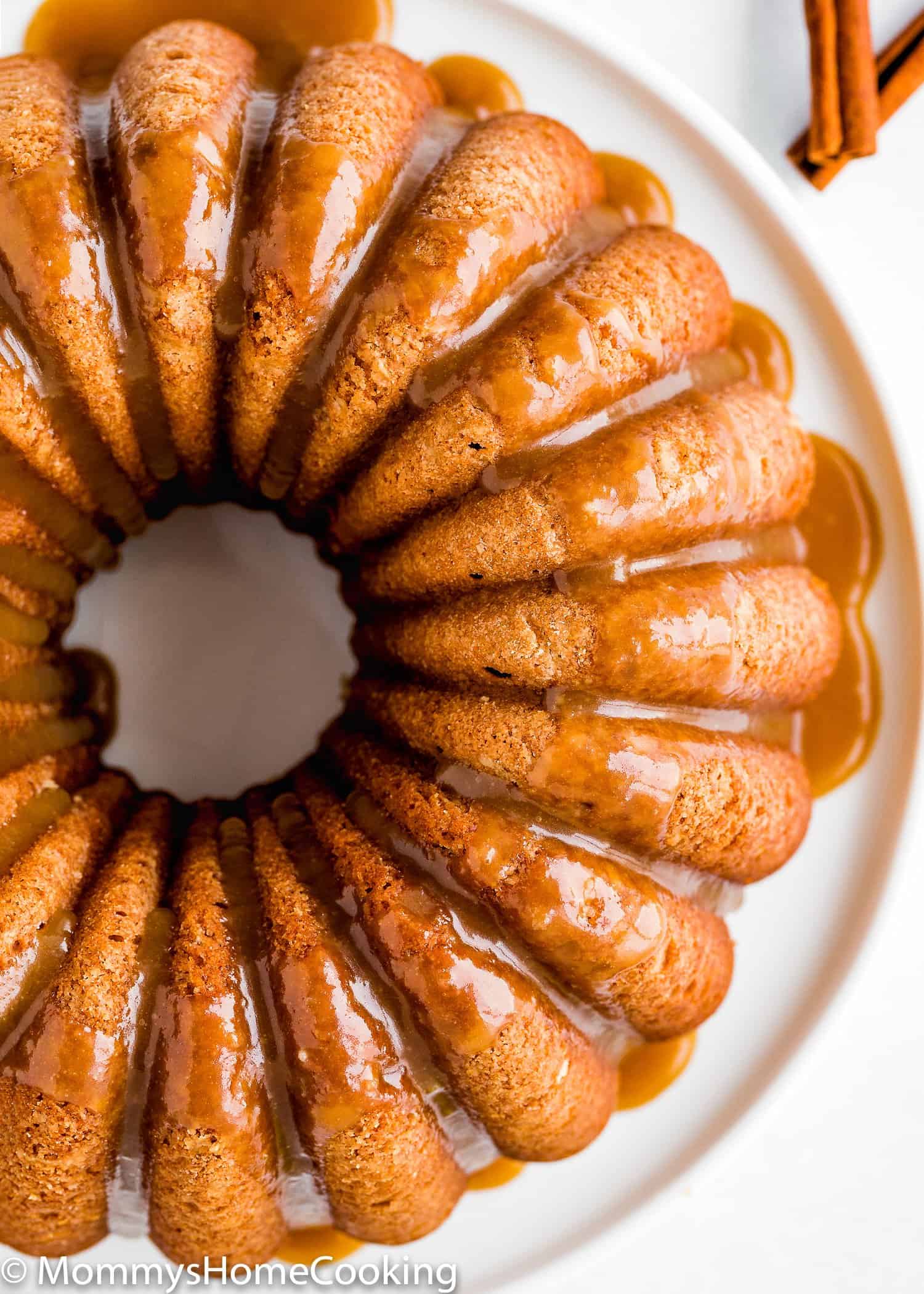 overhead view of a Eggless Apple Cider Donut Cake with brown sugar glaze
