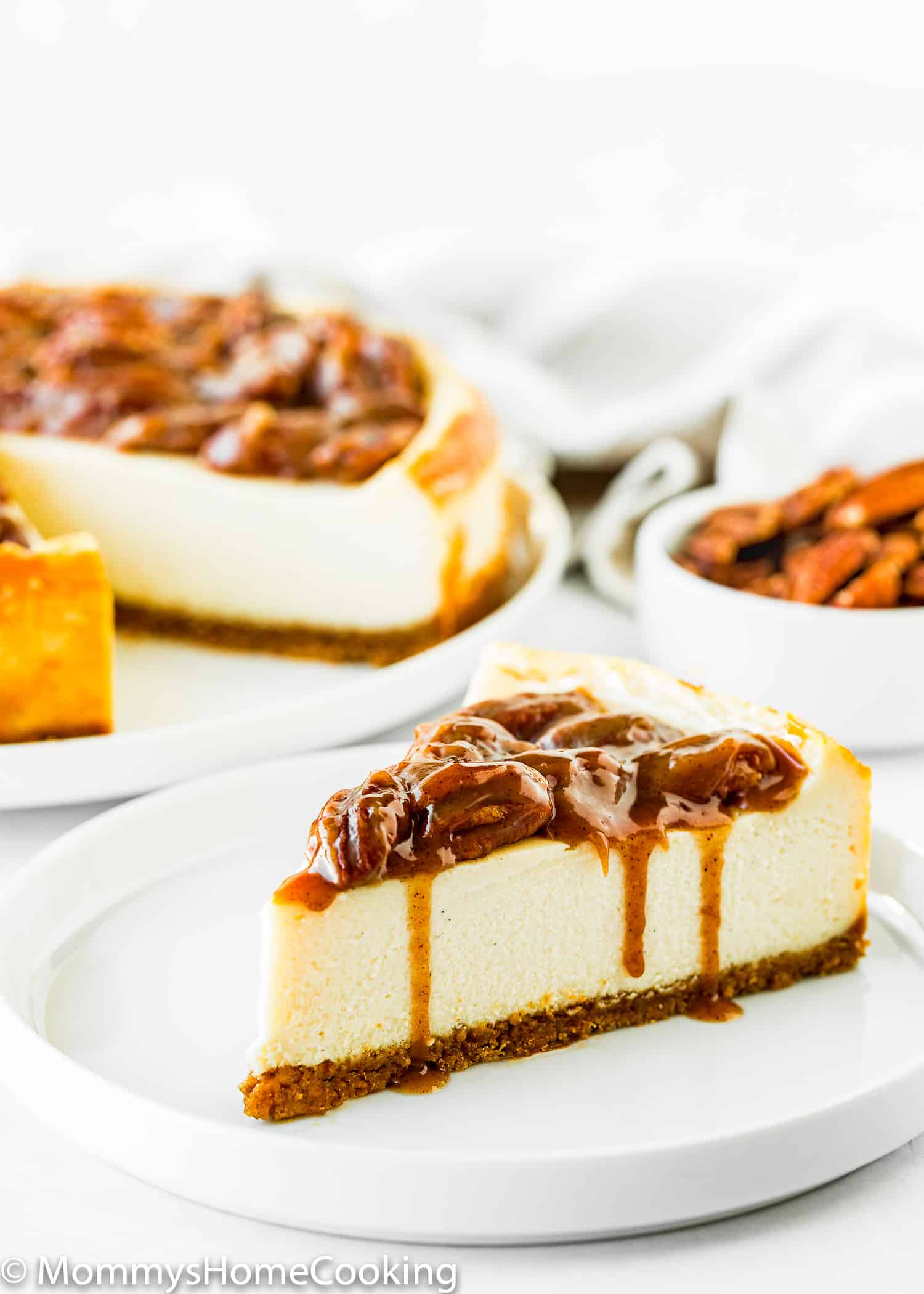 Eggless Pecan Pie Cheesecake slice on a white plate