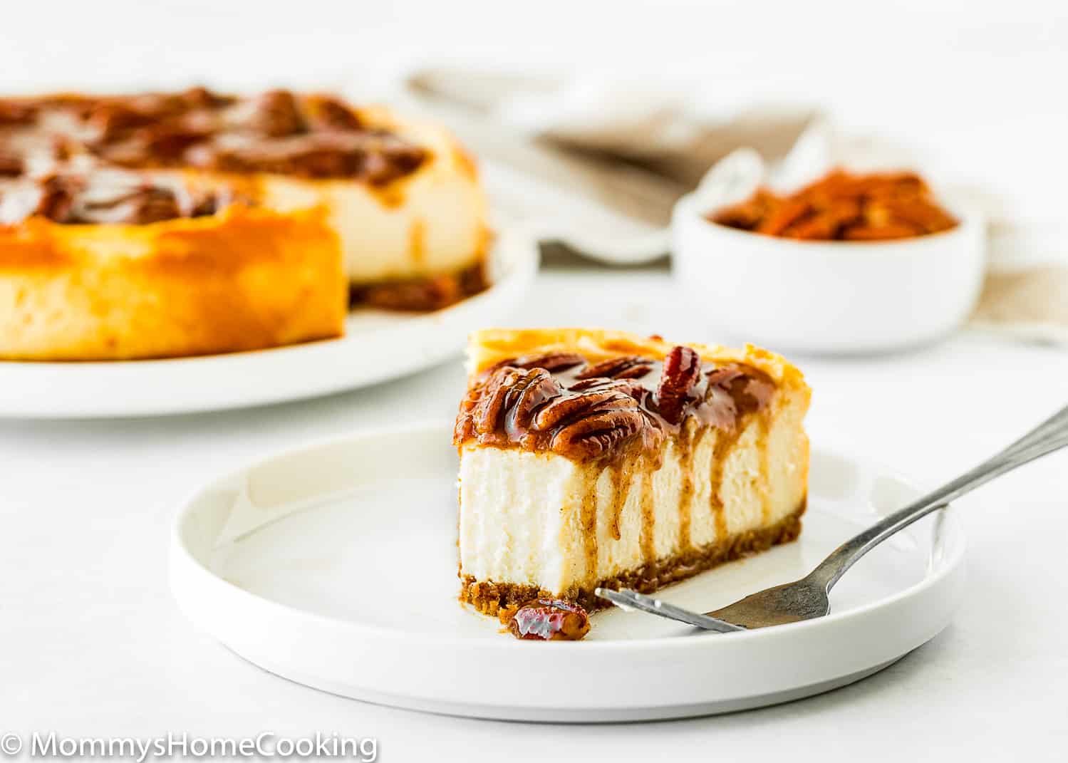 Eggless Pecan Pie Cheesecake spice in a plate showing the creamy inside texture