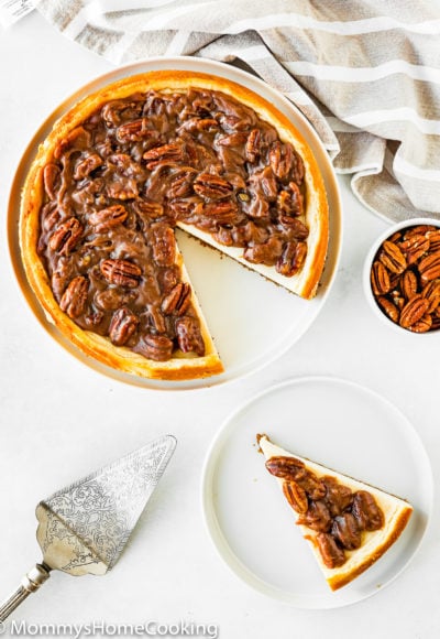 ovehead view of a Eggless Pecan Pie Cheesecake sliced with a cake server