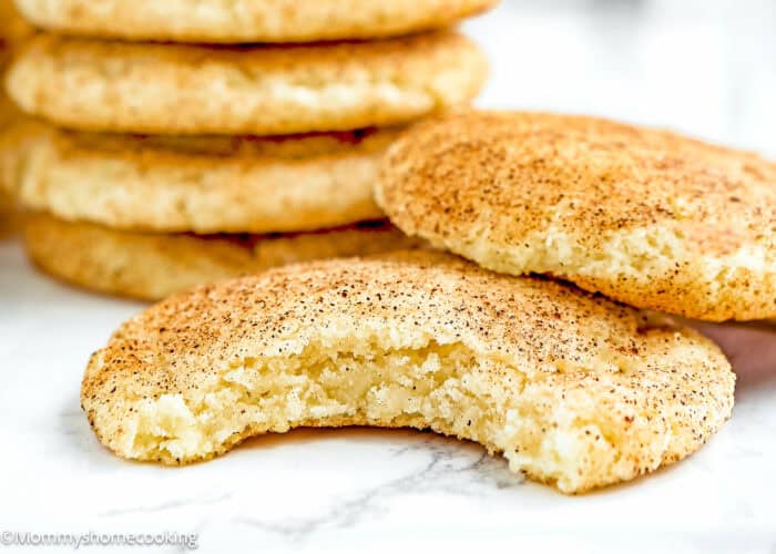 bitten Eggless Snickerdoodle Cookies over a marble surface.